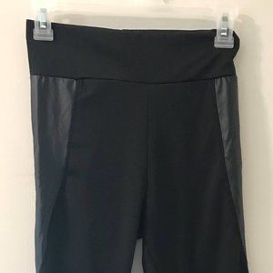Ankle-length black yoga pants with leatherette accents